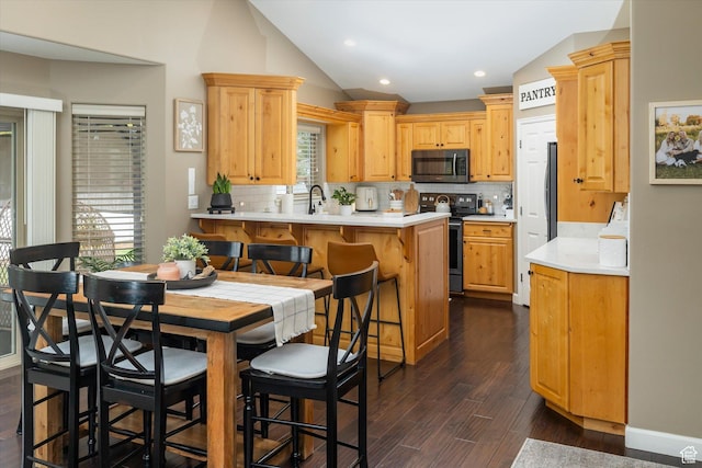 1007 E 2650 N, North Logan, UT 84341 - kitchen featuring stainless steel microwave, electric range, a peninsula, decorative backsplash, and lofted ceiling