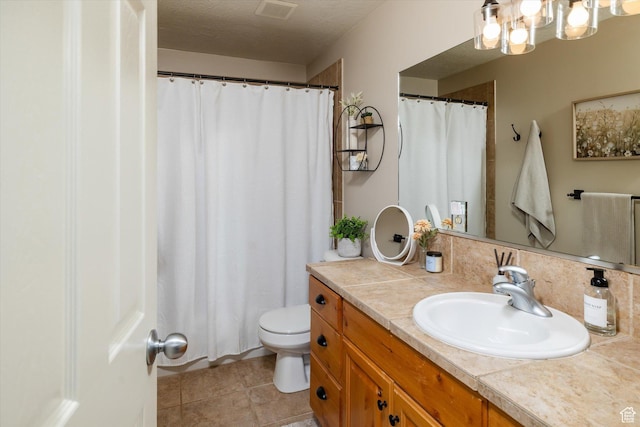 1007 E 2650 N, North Logan, UT 84341 - bathroom featuring vanity, toilet, a chandelier, tile patterned floors, and curtained shower