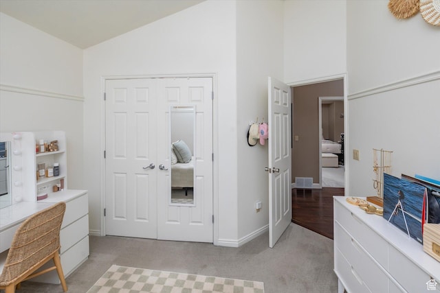 1007 E 2650 N, North Logan, UT 84341 - bedroom featuring a desk, high vaulted ceiling, baseboards, light colored carpet, and a closet