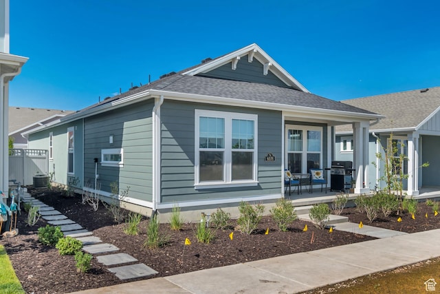 6078 W 11800 S Unit 490, South Jordan, UT 84009 - view of front facade featuring a porch, roof with shingles, and central air condition unit