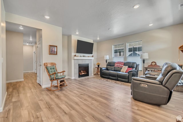 6078 W 11800 S Unit 490, South Jordan, UT 84009 - living room with light wood finished floors, a tiled fireplace, baseboards, and recessed lighting