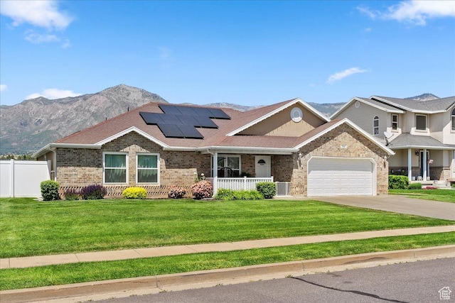 286 W 1875 N, North Ogden, UT 84414 - view of front of property featuring covered porch, brick siding, roof mounted solar panels, driveway, and an attached garage