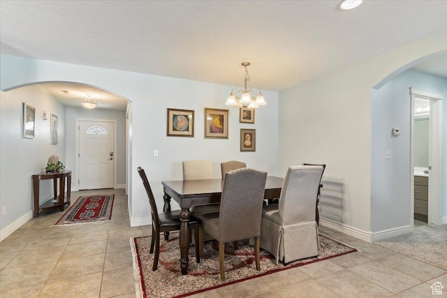 286 W 1875 N, North Ogden, UT 84414 - dining area with arched walkways, light tile patterned flooring, baseboards, and a chandelier