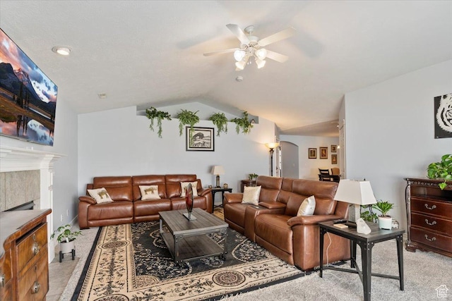 286 W 1875 N, North Ogden, UT 84414 - living area featuring arched walkways, a ceiling fan, light colored carpet, a tile fireplace, and lofted ceiling