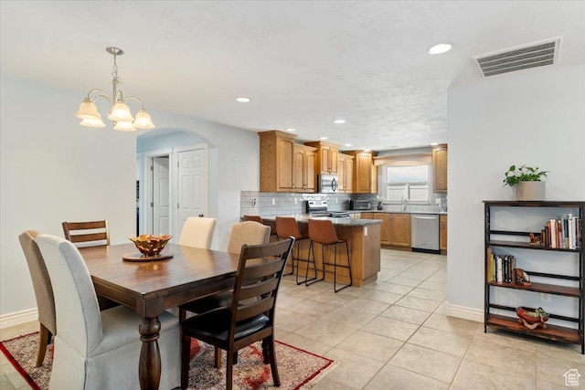 286 W 1875 N, North Ogden, UT 84414 - dining space featuring arched walkways, light tile patterned floors, recessed lighting, a chandelier, and baseboards