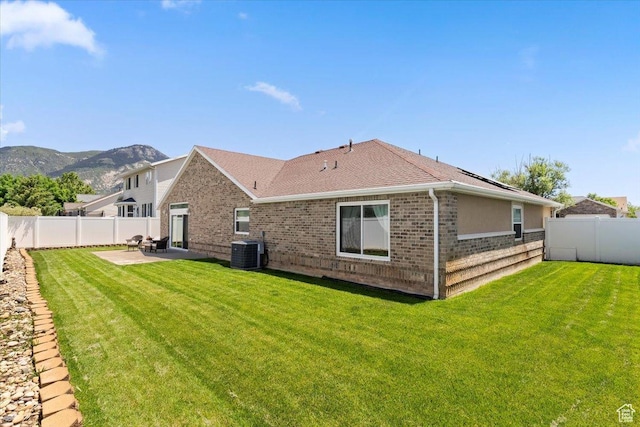 286 W 1875 N, North Ogden, UT 84414 - rear view of house with central AC, a mountain view, a patio, brick siding, and a shingled roof