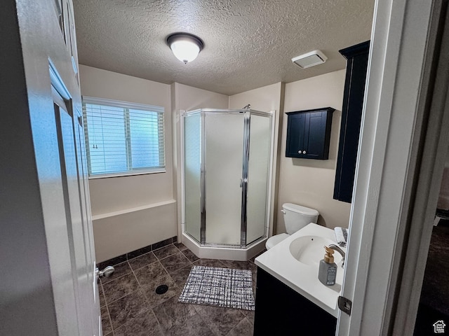 2156 E 3000 N, Layton, UT 84040 - bathroom featuring a shower stall, vanity, a textured ceiling, toilet, and tile patterned floors