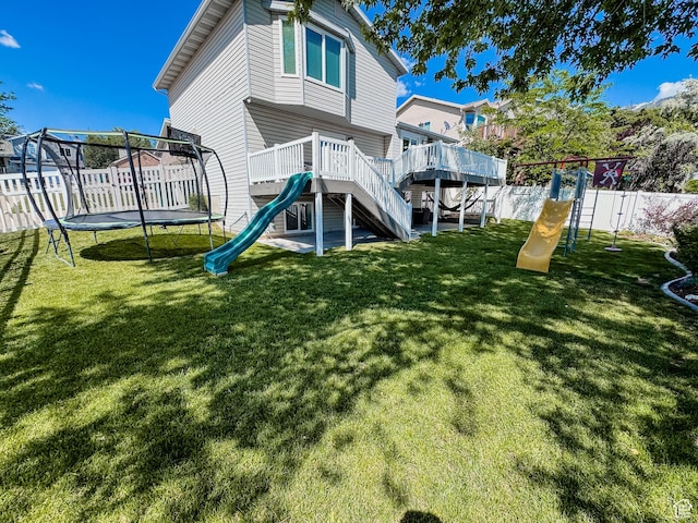 2156 E 3000 N, Layton, UT 84040 - back of house with a trampoline, a playground, and a wooden deck