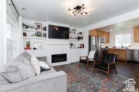 1186 W 200 S, Logan, UT 84321 - living area featuring a chandelier, a fireplace, and built in features