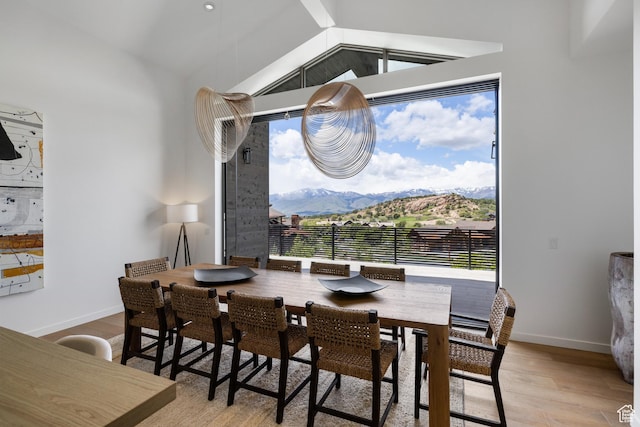 310 Red Ledges Blvd, Heber City, UT 84032 - dining space featuring lofted ceiling, light wood-type flooring, a mountain view, and baseboards