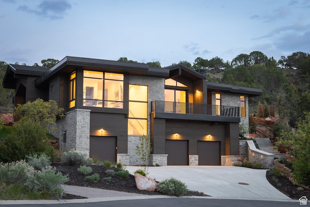 310 Red Ledges Blvd, Heber City, UT 84032 - contemporary house featuring a balcony, stone siding, a garage, and driveway