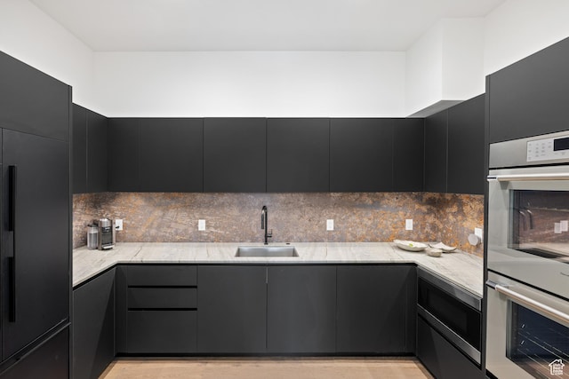 310 Red Ledges Blvd, Heber City, UT 84032 - kitchen featuring a sink, built in appliances, dark cabinetry, decorative backsplash, and modern cabinets