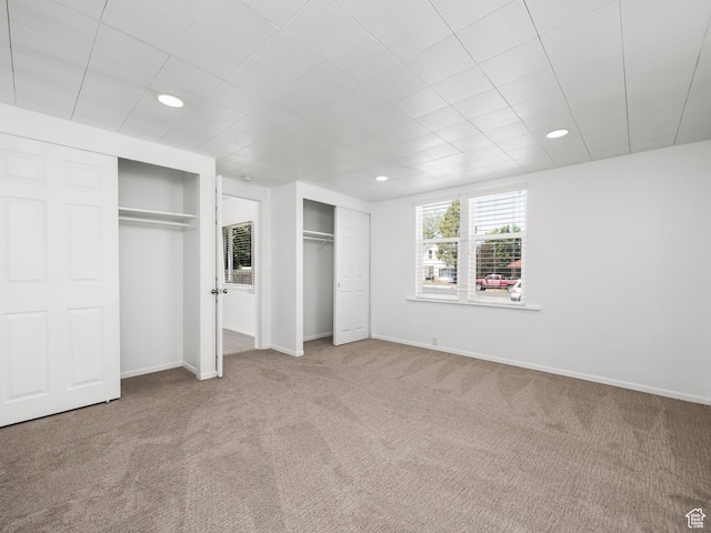 250 N 100 E, Tooele, UT 84074 - unfurnished bedroom with two closets, carpet floors, baseboards, and recessed lighting