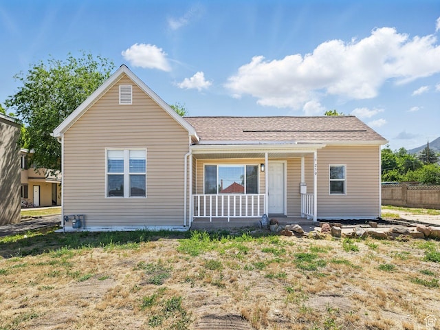 250 N 100 E, Tooele, UT 84074 - view of front facade featuring covered porch and a shingled roof