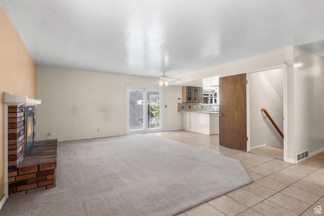1922 E Southbridge Way, Sandy, UT 84093 - unfurnished living room with light tile patterned floors, a fireplace, ceiling fan, and baseboards