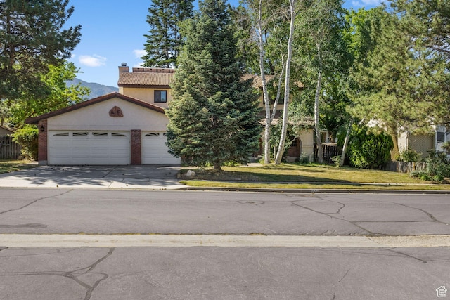 1922 E Southbridge Way, Sandy, UT 84093 - view of front facade featuring concrete driveway, a chimney, a garage, a tiled roof, and stucco siding