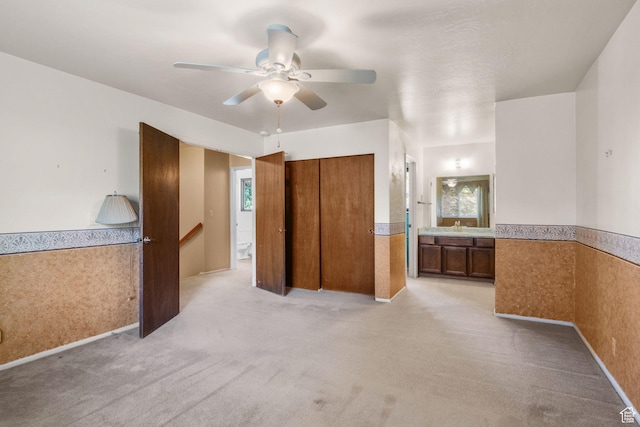 1922 E Southbridge Way, Sandy, UT 84093 - unfurnished bedroom with a wainscoted wall, light colored carpet, ensuite bath, a ceiling fan, and a closet