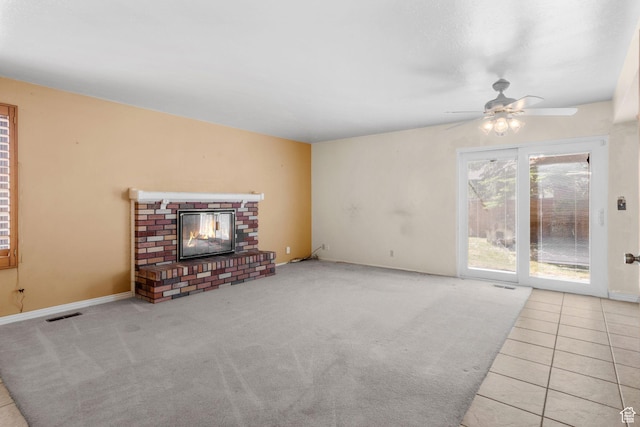 1922 E Southbridge Way, Sandy, UT 84093 - unfurnished living room featuring a ceiling fan, a brick fireplace, baseboards, carpet floors, and tile patterned floors