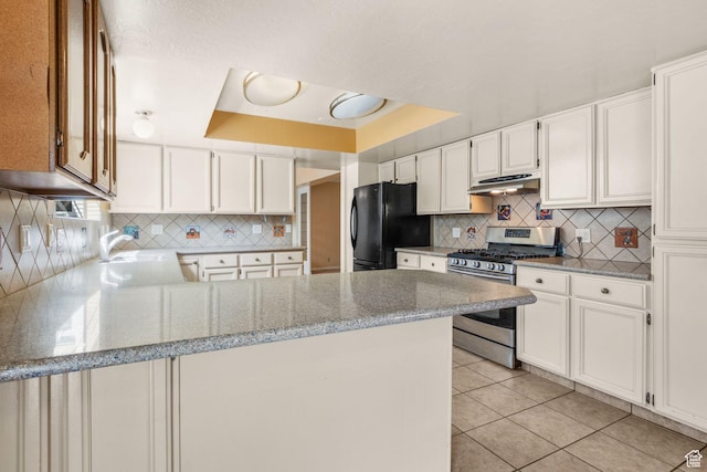 1922 E Southbridge Way, Sandy, UT 84093 - kitchen featuring stainless steel gas range, freestanding refrigerator, under cabinet range hood, a peninsula, and white cabinets