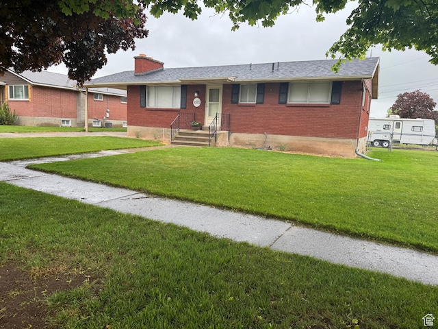 485 N 300 E, Nephi, UT 84648 - ranch-style house with brick siding, a chimney, and a front lawn