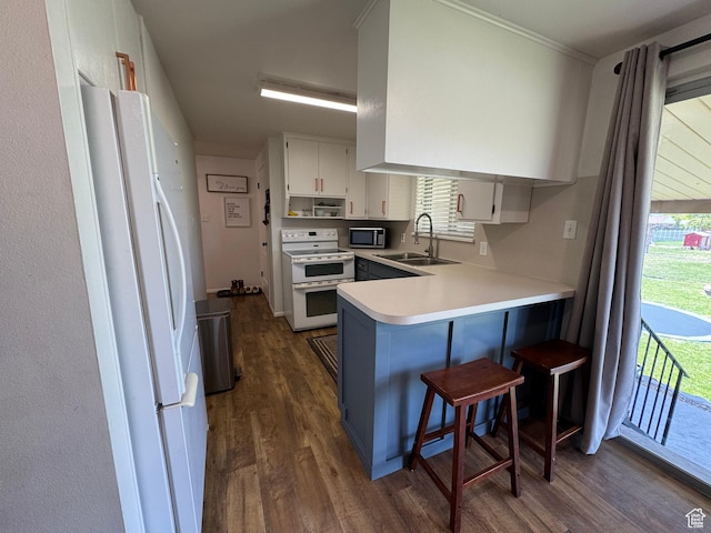 485 N 300 E, Nephi, UT 84648 - kitchen featuring white appliances, a sink, dark wood-style floors, a peninsula, and light countertops