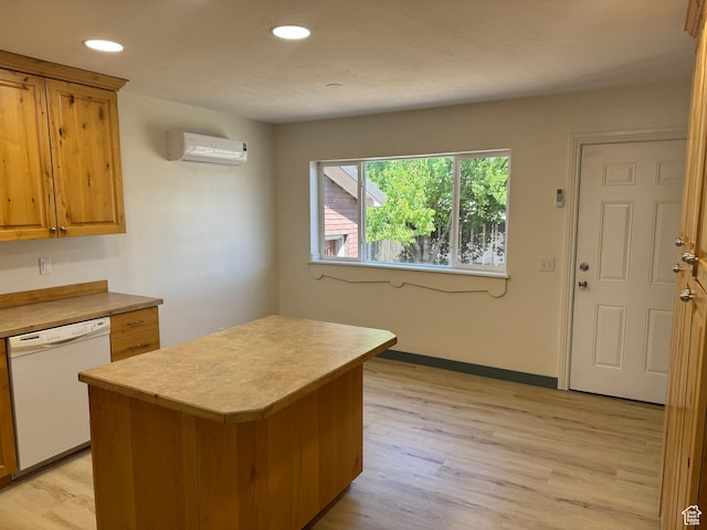 559 E Harmston Ave, Roosevelt, UT 84066 - kitchen with dishwasher, a wall mounted air conditioner, light countertops, light wood-style floors, and a kitchen island