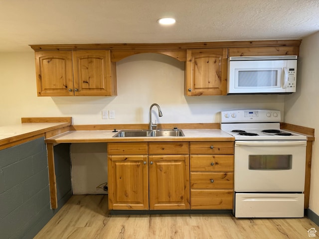 559 E Harmston Ave, Roosevelt, UT 84066 - kitchen with white appliances, a sink, light wood finished floors, light countertops, and brown cabinets