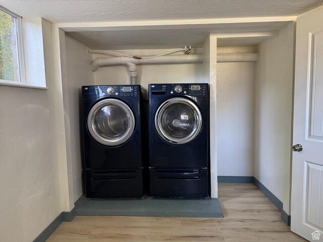 559 E Harmston Ave, Roosevelt, UT 84066 - laundry area with washer and clothes dryer, wood finished floors, and baseboards