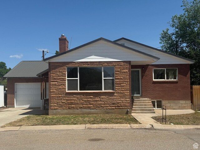 559 E Harmston Ave, Roosevelt, UT 84066 - view of front of home with a garage, driveway, entry steps, and a chimney