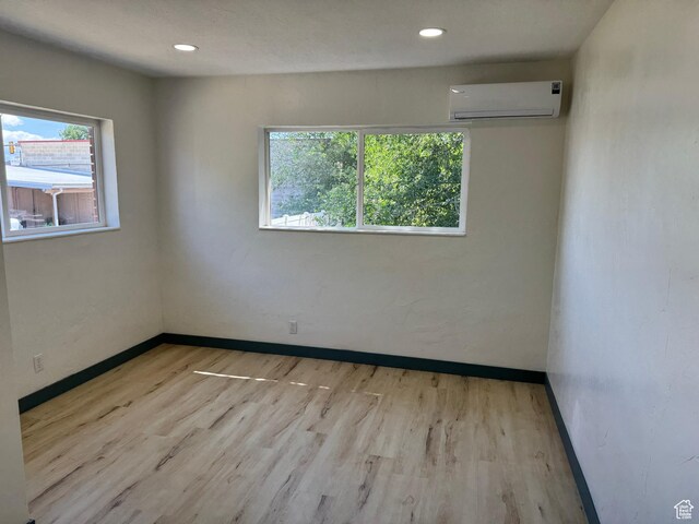 559 E Harmston Ave, Roosevelt, UT 84066 - spare room featuring a wall mounted air conditioner, wood finished floors, baseboards, and recessed lighting