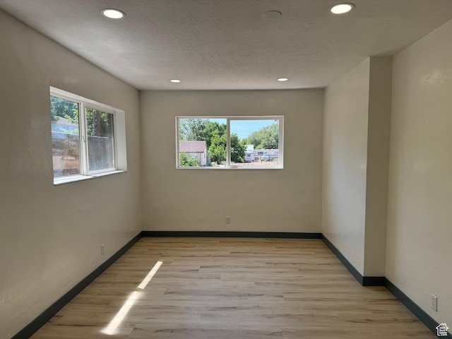 559 E Harmston Ave, Roosevelt, UT 84066 - empty room with light wood-type flooring, recessed lighting, baseboards, and a textured ceiling