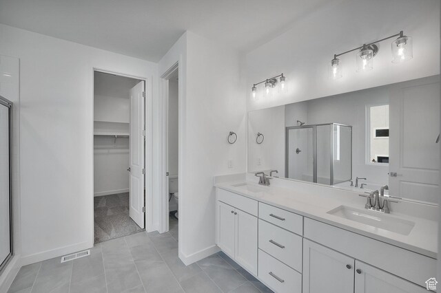 1147 N 375 W Unit 11, Harrisville, UT 84404 - bathroom featuring a stall shower, double vanity, toilet, tile patterned floors, and a spacious closet