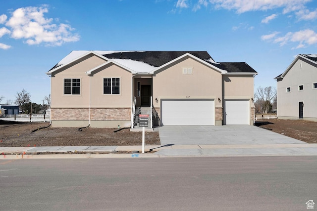 1147 N 375 W Unit 11, Harrisville, UT 84404 - ranch-style house with stucco siding, an attached garage, concrete driveway, and stone siding