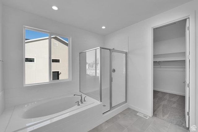 1147 N 375 W Unit 11, Harrisville, UT 84404 - full bath with a garden tub, a stall shower, a walk in closet, recessed lighting, and baseboards