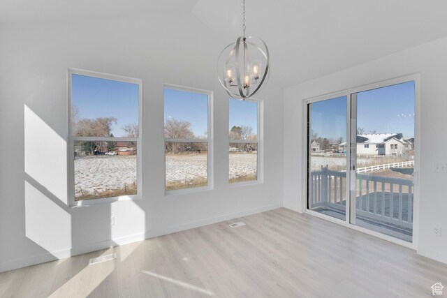 1147 N 375 W Unit 11, Harrisville, UT 84404 - unfurnished dining area with a chandelier, healthy amount of natural light, wood finished floors, and lofted ceiling