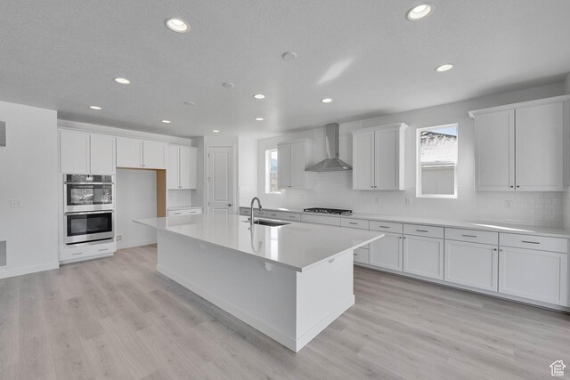 1147 N 375 W Unit 11, Harrisville, UT 84404 - kitchen with a sink, wall chimney exhaust hood, double oven, recessed lighting, and white cabinetry