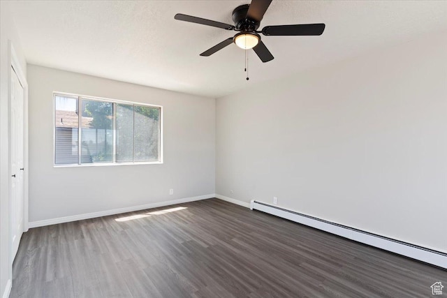 190 W 1100 N, Logan, UT 84341 - spare room featuring baseboard heating, dark wood finished floors, baseboards, and ceiling fan