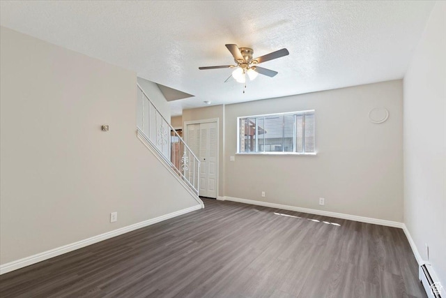 190 W 1100 N, Logan, UT 84341 - unfurnished living room featuring a baseboard heating unit, dark wood-type flooring, a ceiling fan, baseboards, and a textured ceiling