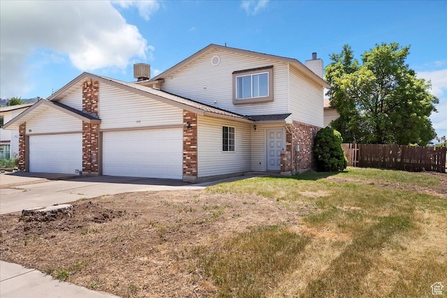 190 W 1100 N, Logan, UT 84341 - view of front facade with a chimney, an attached garage, brick siding, and driveway