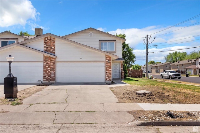 190 W 1100 N, Logan, UT 84341 - traditional-style house with brick siding, driveway, a garage, and cooling unit