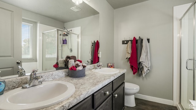 1026 E Searle Ln, Eagle Mountain, UT 84005 - full bath with a shower stall, double vanity, wood finished floors, baseboards, and toilet