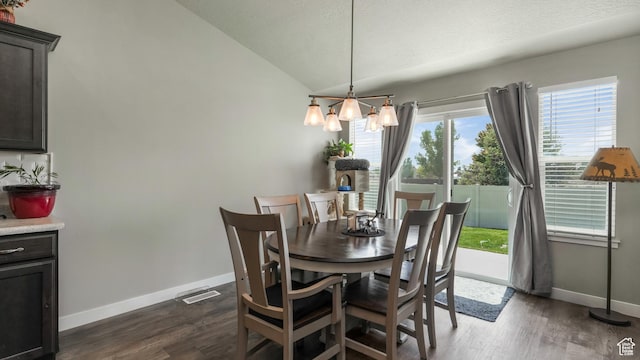 1026 E Searle Ln, Eagle Mountain, UT 84005 - dining area with lofted ceiling, dark wood-type flooring, baseboards, a textured ceiling, and a chandelier
