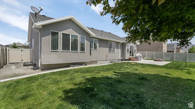 1026 E Searle Ln, Eagle Mountain, UT 84005 - back of property featuring a patio, a gate, stucco siding, and entry steps