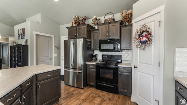1026 E Searle Ln, Eagle Mountain, UT 84005 - kitchen with black appliances, light countertops, backsplash, dark brown cabinetry, and lofted ceiling