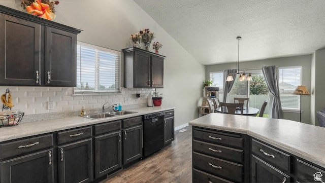 1026 E Searle Ln, Eagle Mountain, UT 84005 - kitchen with a sink, dishwasher, dark wood-style flooring, vaulted ceiling, and a textured ceiling