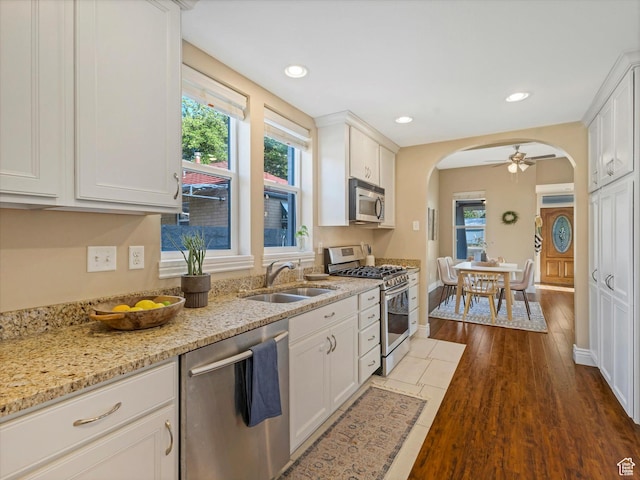932 W 600 N, Salt Lake City, UT 84116 - kitchen featuring stainless steel appliances, a sink, arched walkways, white cabinets, and recessed lighting