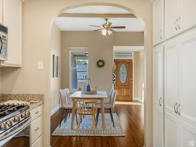 932 W 600 N, Salt Lake City, UT 84116 - dining area with arched walkways, ceiling fan, dark wood finished floors, and baseboards