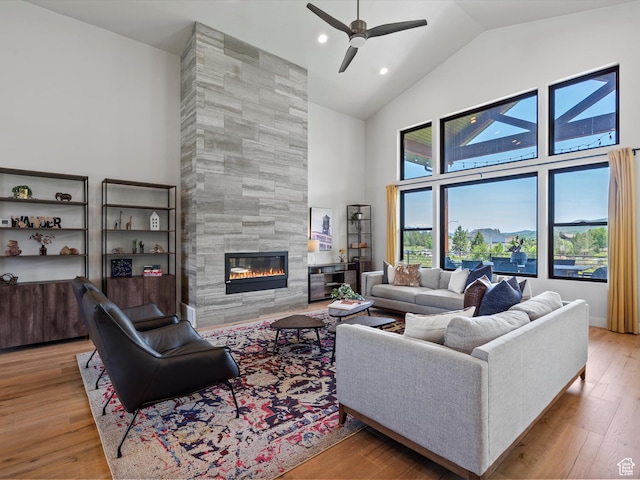 4021 E 4325 N, Eden, UT 84310 - living room featuring high vaulted ceiling, a tile fireplace, a ceiling fan, wood finished floors, and recessed lighting