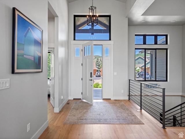 4021 E 4325 N, Eden, UT 84310 - foyer entrance featuring a chandelier, baseboards, wood finished floors, and a towering ceiling