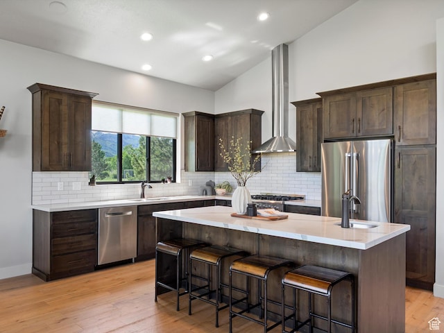 4021 E 4325 N, Eden, UT 84310 - kitchen with appliances with stainless steel finishes, wall chimney range hood, lofted ceiling, a sink, and dark brown cabinetry